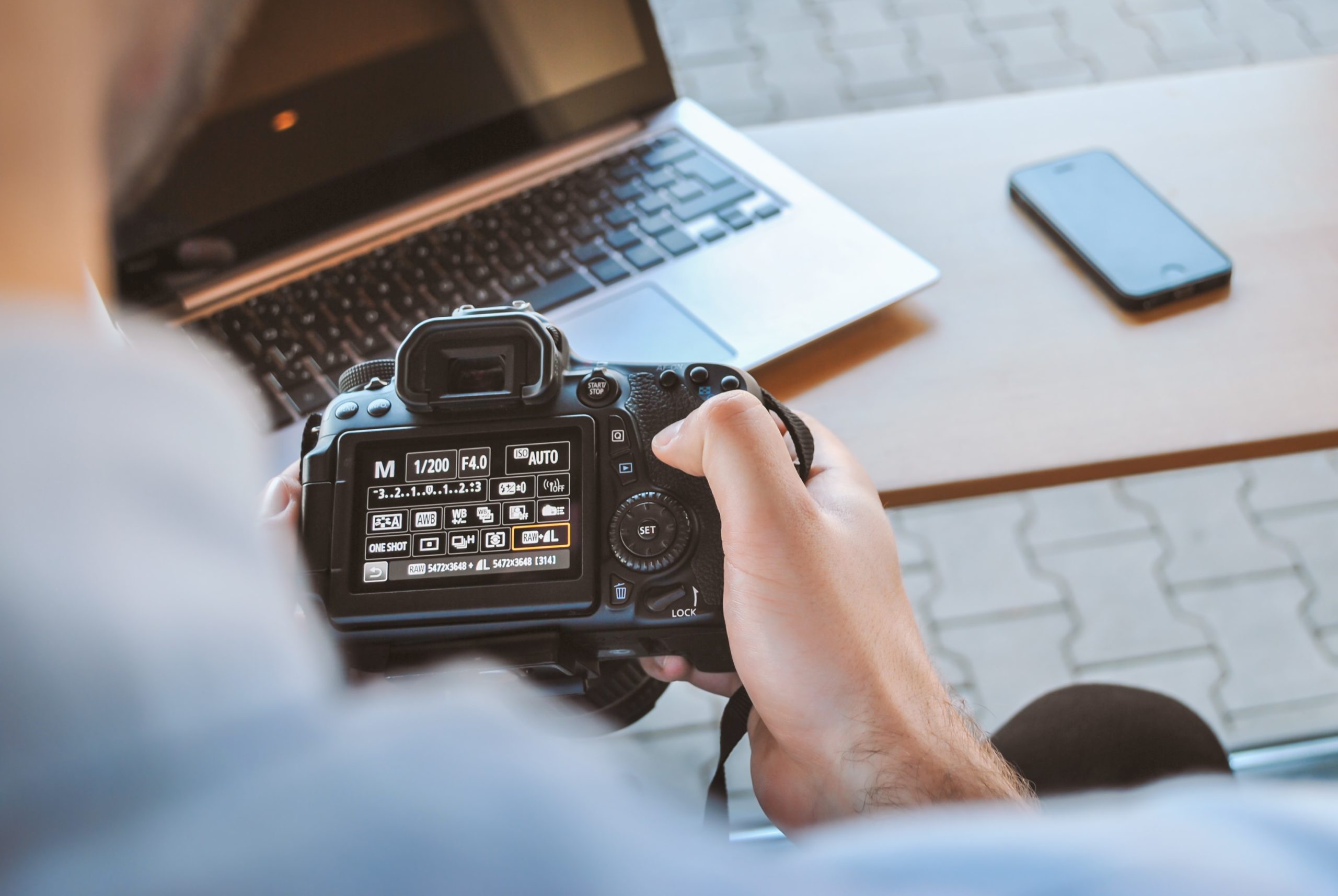 Man changing settings on canon camera for a high resolution photo