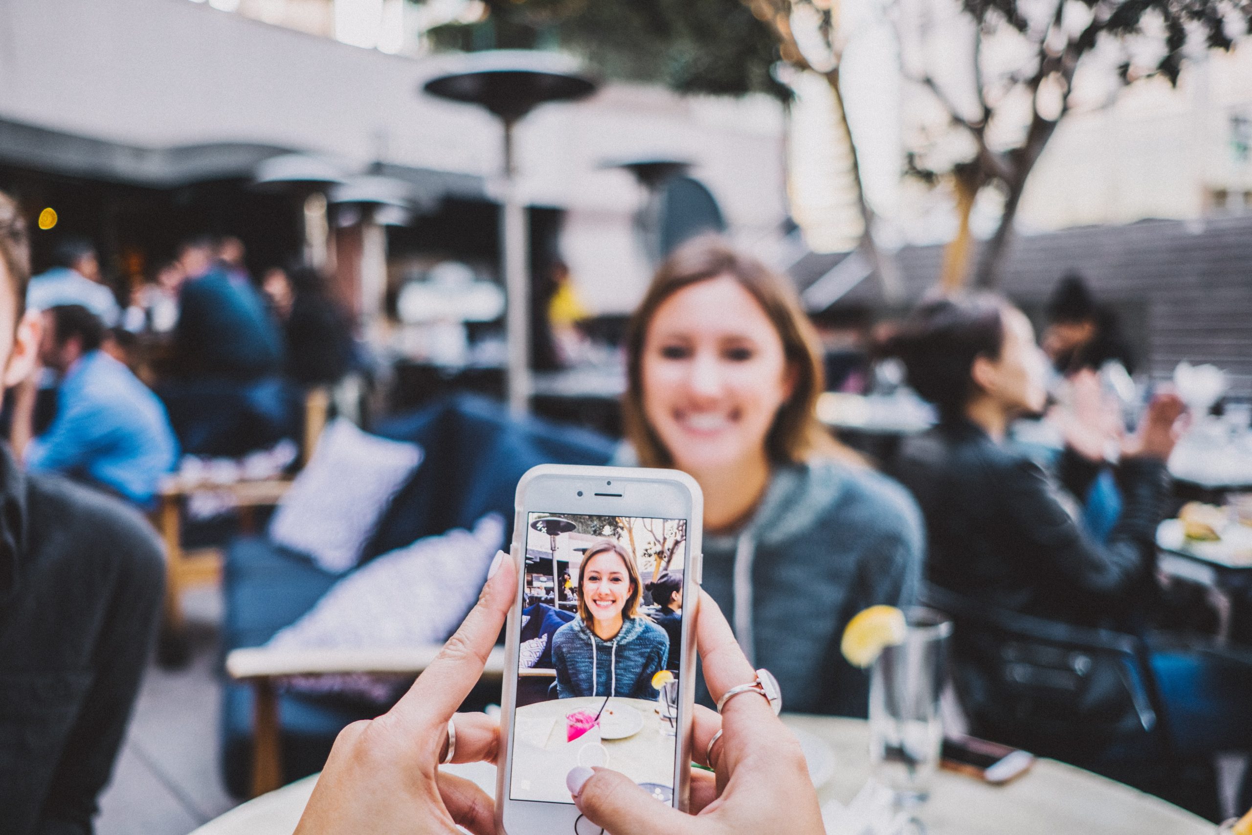 Taking a photo of a friend on an iPhone