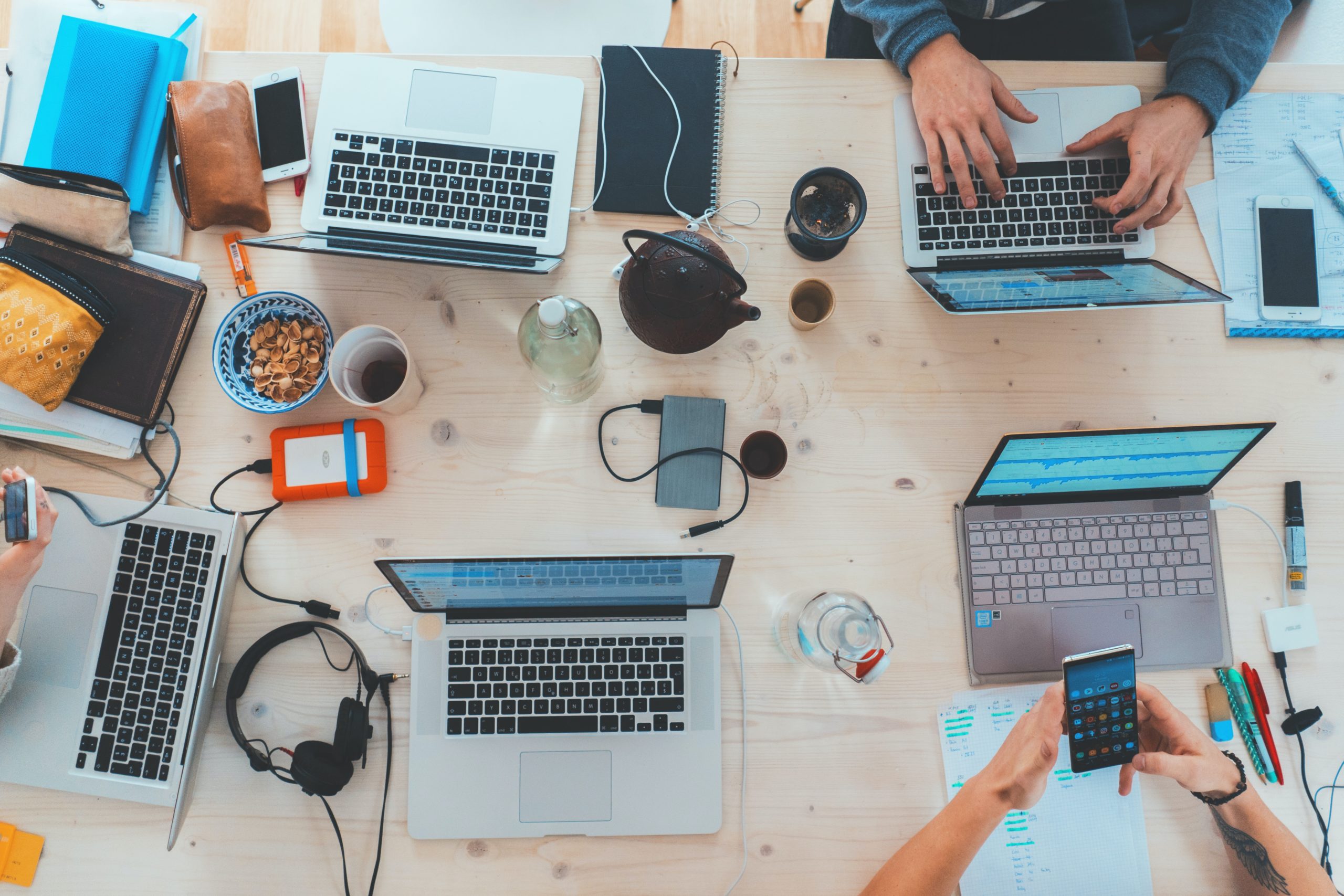 group of individuals with laptops, developing content strategies