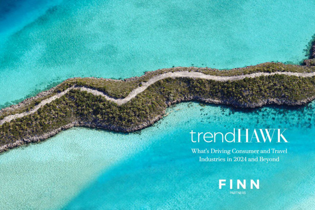 Aerial view of a winding green land strip surrounded by turquoise waters, with 'trendHAWK' text and 'FINN Partners' logo.