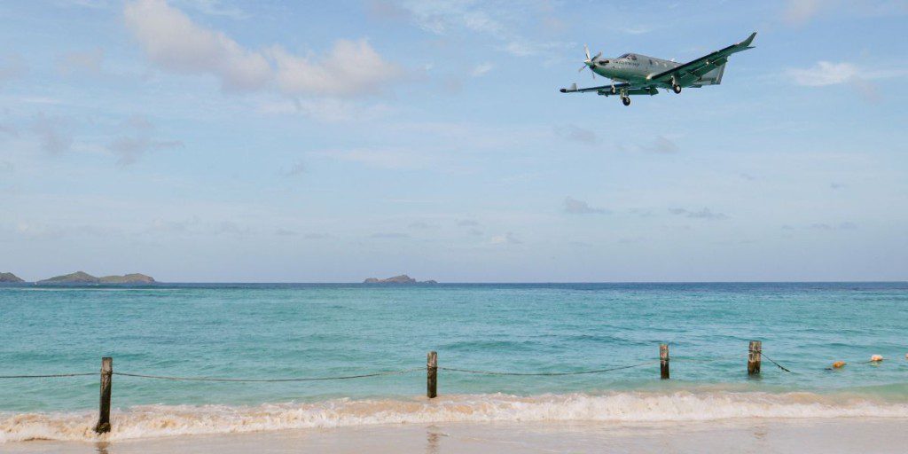 Airplane flying over a beach