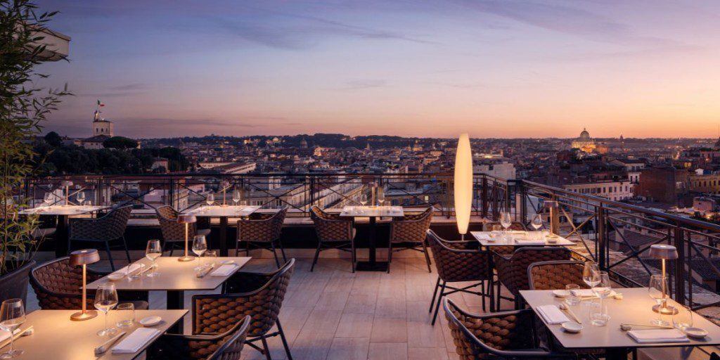 Terrace restaurant overlooking a city landscape at dusk