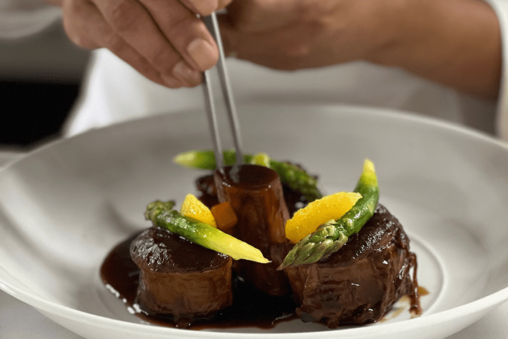 a simple dish featuring beef medallions topped with asparagus